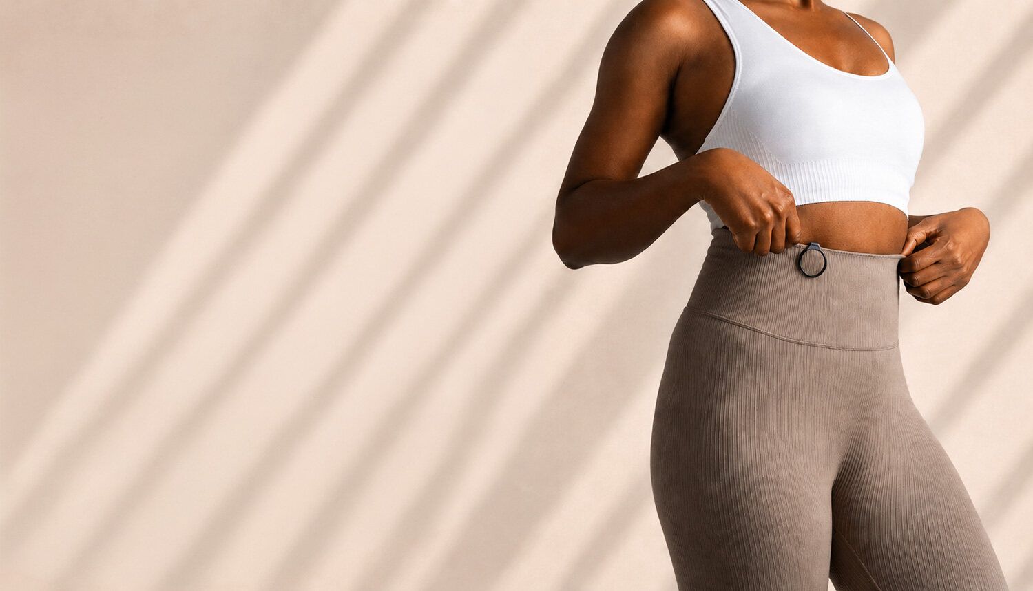 A woman in a white top wearing the Vire Clip.