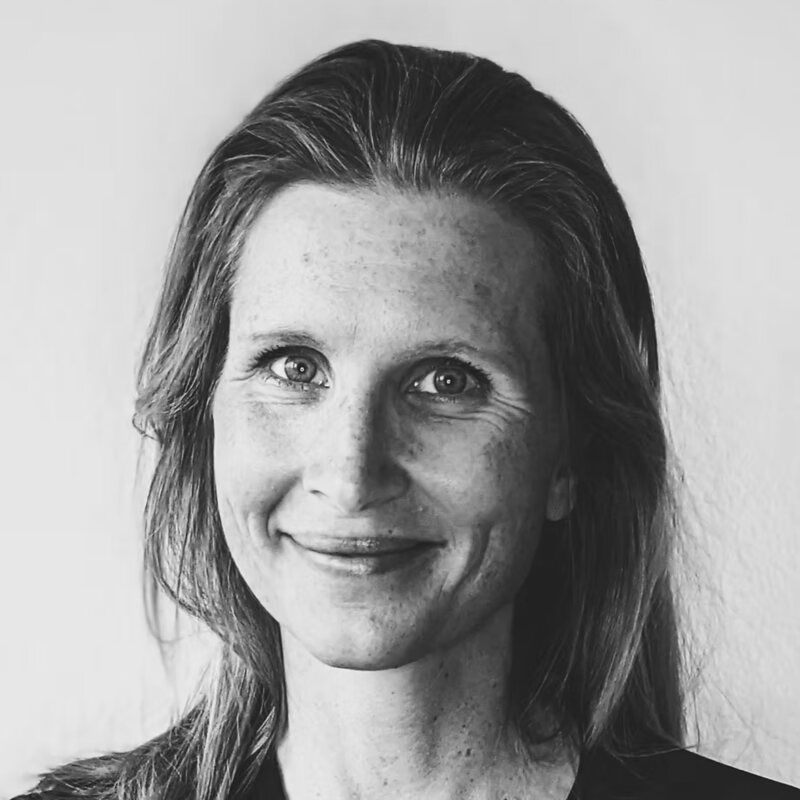 Lisa Falco, smiling, in a black-and-white portrait.