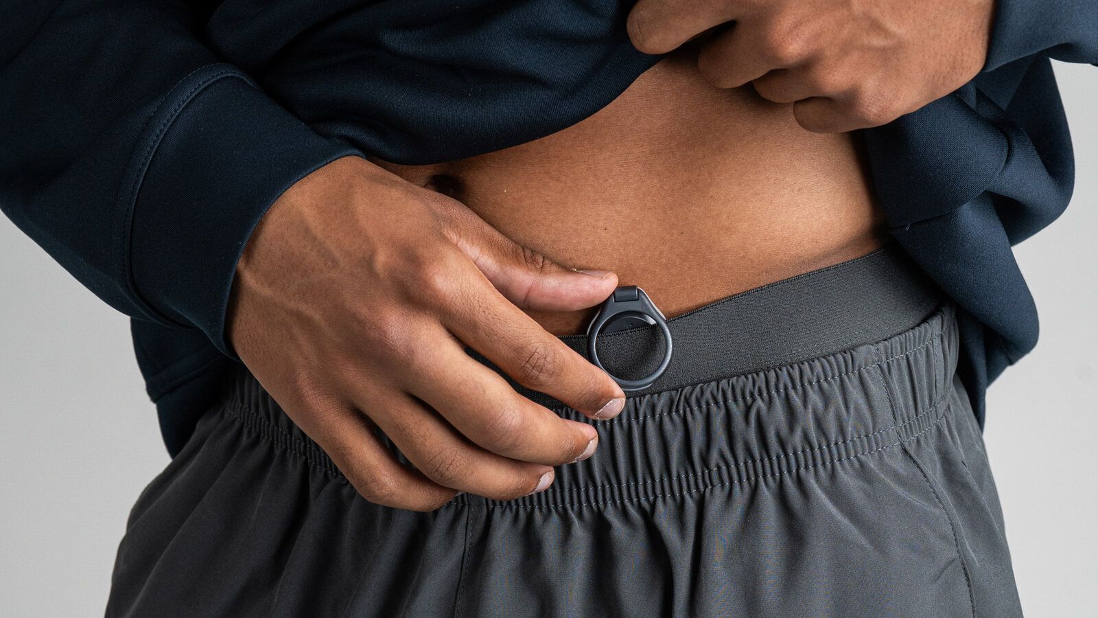 The Vire Clip on the waistband of black shorts.